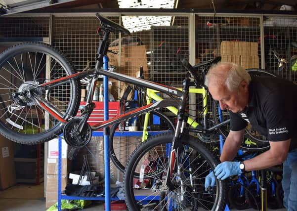 Bikeability Instructor Martin Child renovating a bicycle destined for an NHS worker SUS-200615-142536001