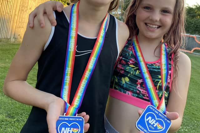 Eden and Indie with their medals after completing 100km in a month