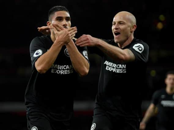 Neal Maupay and Aaron Mooy celebrate the winner at Arsenal last December