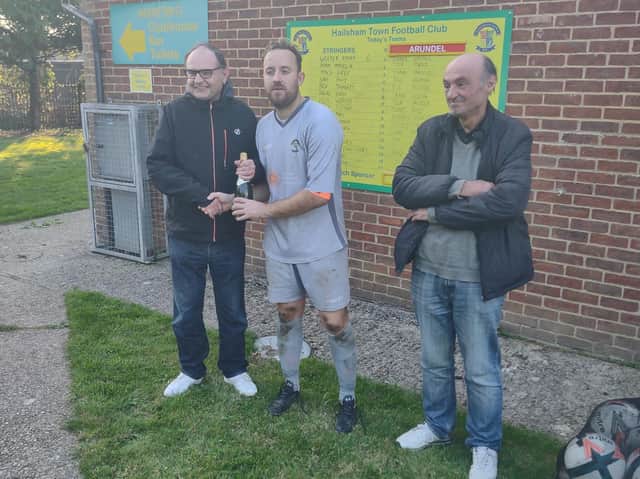 Match sponsors Steve and Alun Thomas present the man of the match award to Hailsham Town's Wester Young
