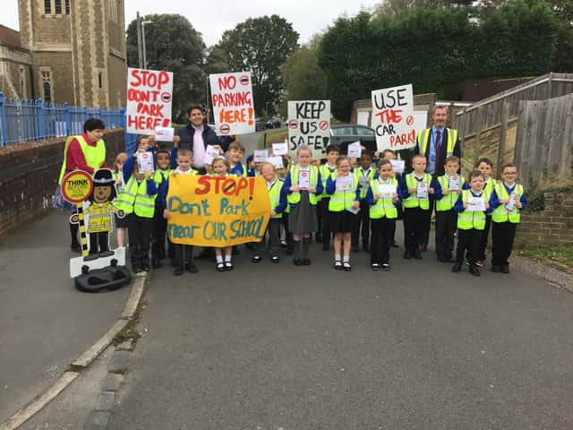 Bexhill MP, Huw Merriman with children and staff at All Saints School in Sidley, Bexhill holding their protest SUS-211210-125855001