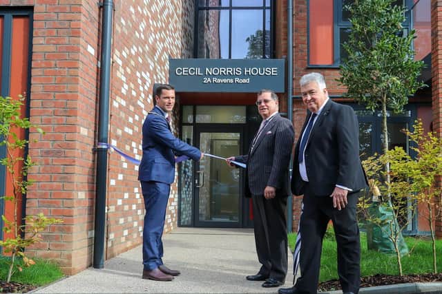 Stephen Chipp cuts the ribbon with Carson Albury and Neil Parkin