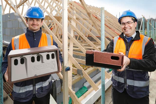 Pictured are DW Homes' Mark Wheeler on the left with a sparrow brick nest box and Gabriel Brandao on the right, with a swift brick nest box