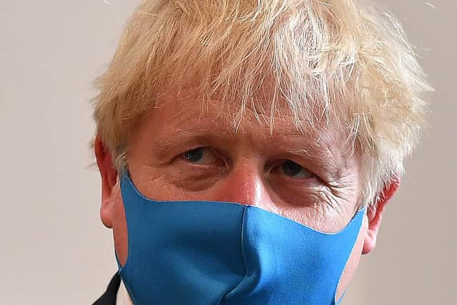 LONDON, UNITED KINGDOM - JULY 13: Britain's Prime Minister Boris Johnson, wearing a face mask or covering due to the COVID-19 pandemic, visits the headquarters of the London Ambulance Service NHS Trust  on July 13, 2020 in London, England.  (Photo by Ben Stansall-WPA Pool/Getty Images) NNL-210427-115201001