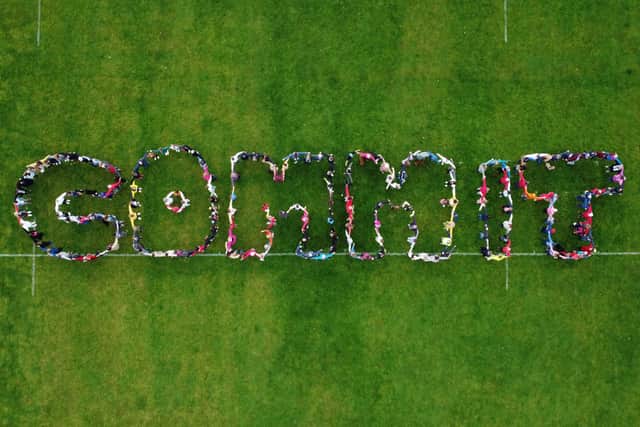 Chichester residents came together to spell the word 'commit' as a nod towards the COP26 conference taking place this weekend. Picture by Dan Hill