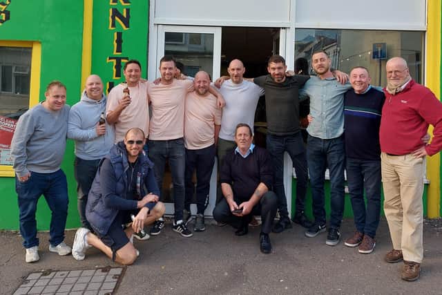 Steve Philbey, centre, with friends and visitors to his shop in St Leonards. Picture by Danny Wood SUS-211027-102720001