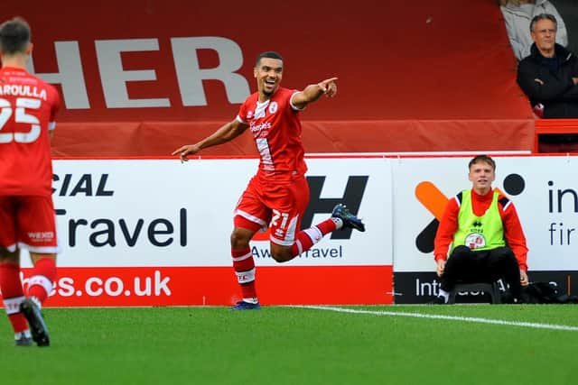 Kwesi Appiah wheels away in celebration after putting ten-man Crawley Town ahead on the stroke of half-time.