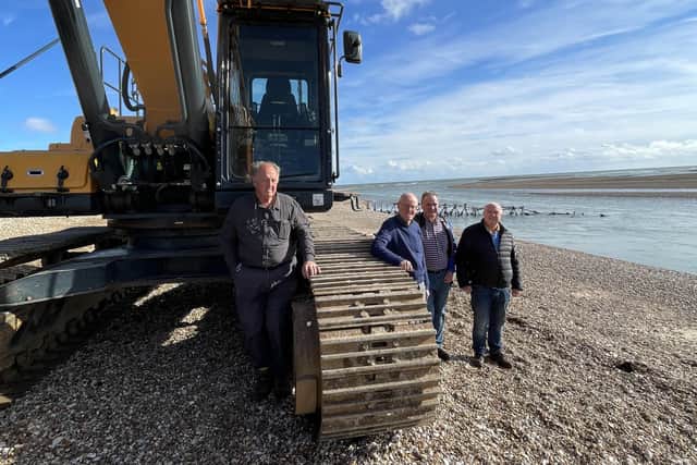 The 50 tonne excavator testing the depth of channel between the shore and the Spit at low tide on Saturday, October 30, as work starts to split Pagham Spit