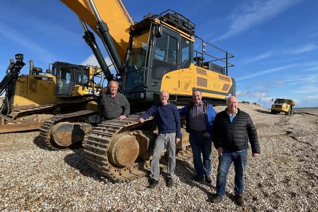 Work starts to split Pagham Spit, From left Peter Atkins (Pagham Flood Defence Trust); Nick Gibb MP; Robin Henderson; Adrian Tindle (consulting engineer) in front of the 50 tonne excavator.