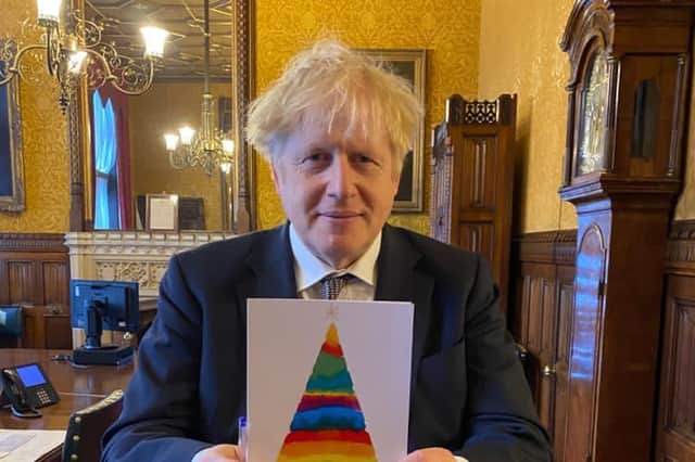 Arundel and South Downs MP has launched his Christmas card competition. Boris Johnson hold last year's winner card.