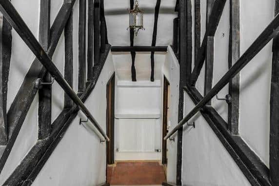 View of stairs and the beams of the internal timber frame of Blake's Cottage