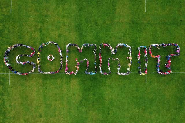 Residents spell out the word commit