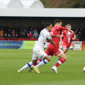 Tom Nichols battles for the ball with former Red Josh Dacres-Cogley