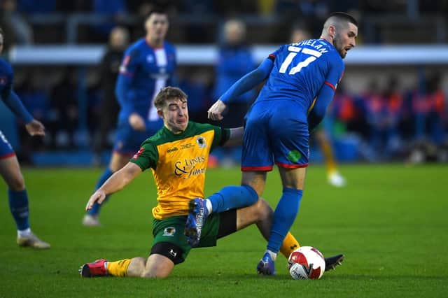 Horsham's Charlie Hester-Cook puts in a strong challenge on Carlisle United's Corey Whelan in Saturday's FA Cup first round clash at Brunton Park. Picture by Stu Forster/Getty Images