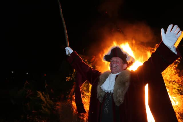 Cuckfield Mayor Andy Leask celebrates the traditional lighting of the bonfire at Cuckfield Bonfire 2021.