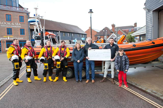 Littlehampton Rugby Club presents a cheque for £1,830 to Littlehampton RNLI in memory of three former members