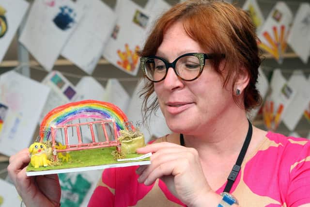 Sam Hobbs, leader of creative arts at The Angmering School with the winning design for a community bench by Safiya, Lily and Ruby. Photo by Derek Martin DM21060806a