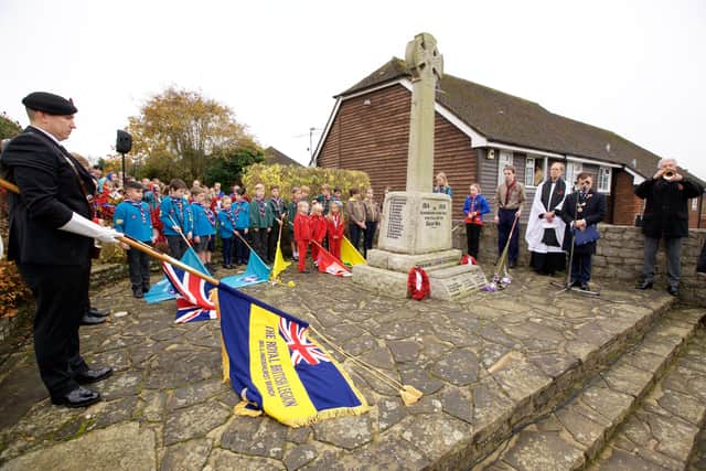 The standards are lowered at the war memorial in Billingshurst