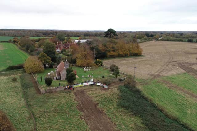 Campaigners say diggers have scarred the grey route up to the village church