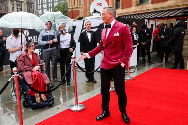 June, wearing the 007 top, and Andy, in the grey jacket, having a chat with Daniel Craig at the world premiere of No Time To Die. Photo by Chris Jackson/Getty Images for EON Productions, Metro-Goldwyn-Mayer Studios, and Universal Pictures 775717441