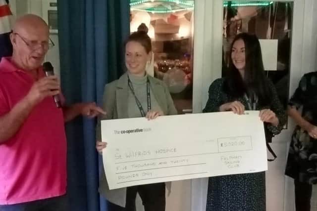 Ross Fisher presents the cheque to St Wilfrids Hospice