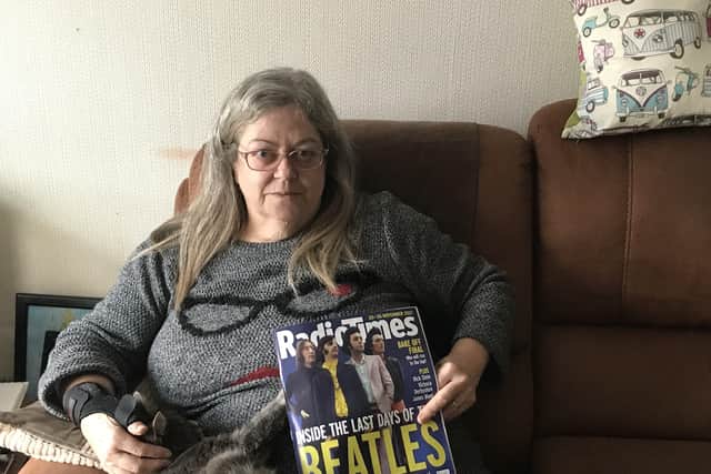 Jeanne Lofts with a magazine that she had to buy as her subscription was late due to the delay in deliveries SUS-211123-141713001