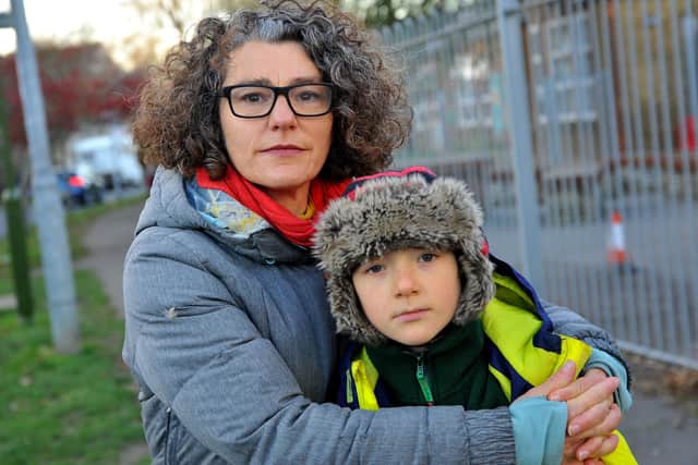 Road safety concerns at Swiss Gardens Primary School. Emma Turner and her son at the crossing point where he was in an incident on the road outside the school. Pic S Robards SR2111221 SUS-211122-170154001