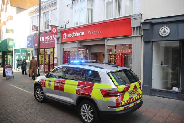 Man superglues himself to counter in Vodafone store in Montague Street Worthing this morning. Photo: Eddie Mitchell