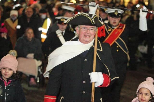 Richard Plowman, the town crier led the parade towards the cross from East Street