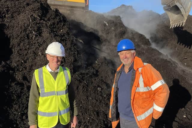 Nick Gibb with John Pitts at Woodhorn Farm, Oving. The pile behind is about 12 weeks through the process. The steam is water evaporating due to the heat generated by the compositing process