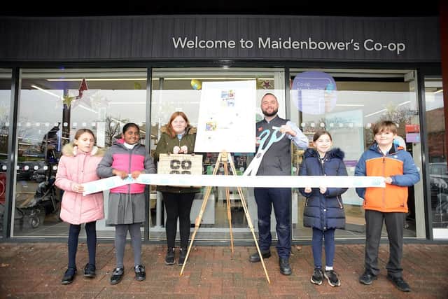 (l to r) Emily Roberts Justino, 8, Juanita Ananth, 8, Faith Hubbard, 10, store manager Tom Harper, Anna Churchill, 9, Max Spindler, 11, all from the local Maidenbower Junior School