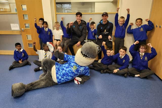 Sid the Shark, Ali Orr and Jamie Atkins  with the children of Our Lady Queen of Heaven Primary School