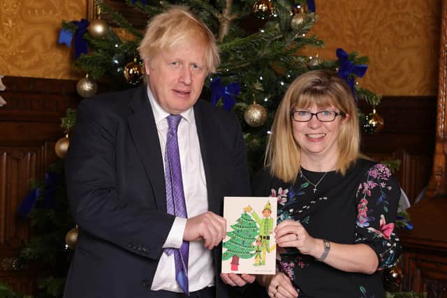 Maria Caulfield MP with the Prime Minister Boris Johnson MP and the winning Christmas card design by Alaya from Polegate School