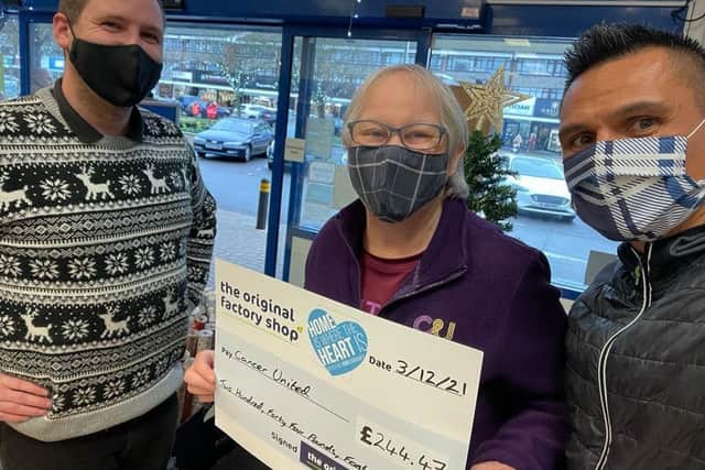 Michael Bailey, store manager at The Original Factory Shop in Rustington, left, presents the cheque to Cancer United founder member and volunteer Yvonne Curling and lead trainer Dwayne Clevett
