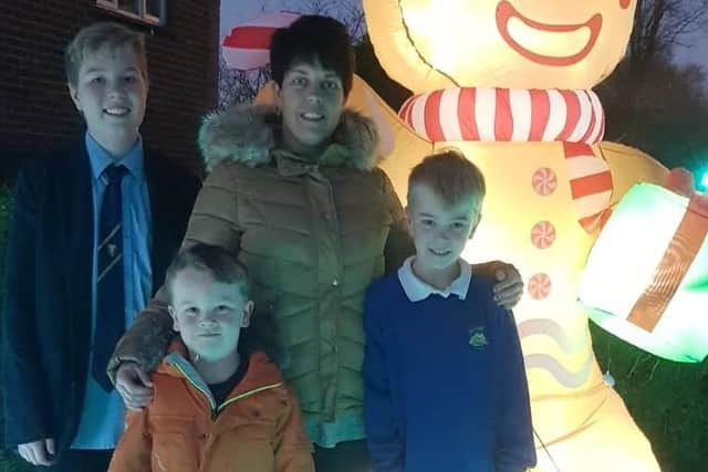 Balcombe mum Heidi Gilbert with her sons Ryan, Shane and Max next to their Christmas display.