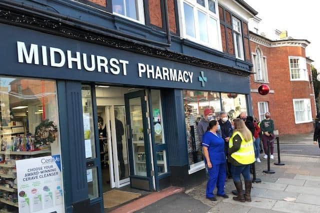 People queue outside the Midhurst Pharmacy