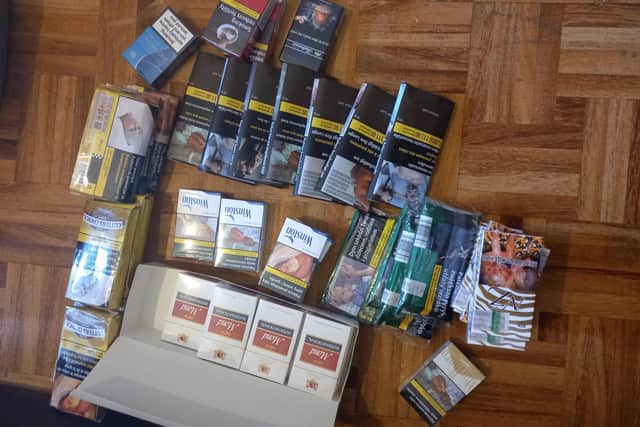 A total of 205 packets of illegal cigarettes and 63 packets of tobacco were found at one of the shops.