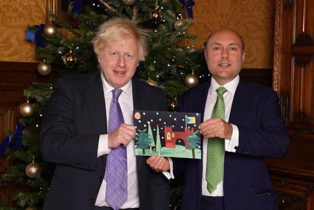 Prime Minister Boris Johnson is presented with the winning Christmas card by Arundel and South Downs MP Andrew Griffith. Picture: Andrew Parsons CCHQ / Parsons Media PAR-7554