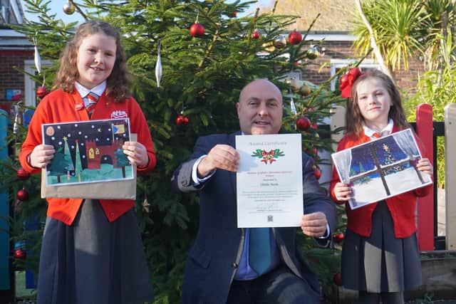 Winner Ottilie Seeds, left, and runner-up Poppy Pritchett from Arundel Church of England Primary School with Arundel and South Downs MP Andrew Griffith