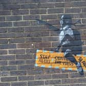 New street art, thought to be a Banksy, appeared on a wall in Crawley in August