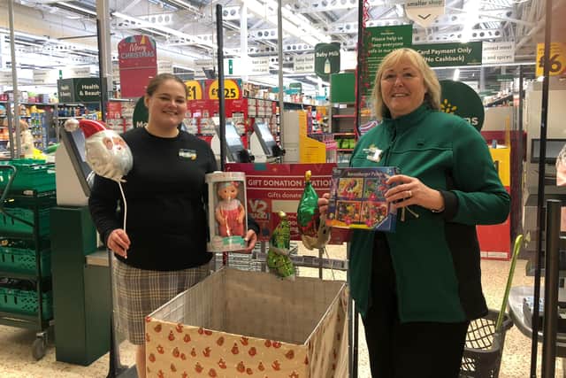 Alison Whitburn, community champion, and Helena Sherriff, one of the managers, with toys donated at Morrisons Littlehampton for the V2 Radio Christmas Toy Appeal SUS-211130-104918003