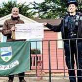 PCSO Sophie Cole presenting the £500 cheque to East Dean and Friston Bowls Club. Picture from Sussex Police SUS-220201-162631001