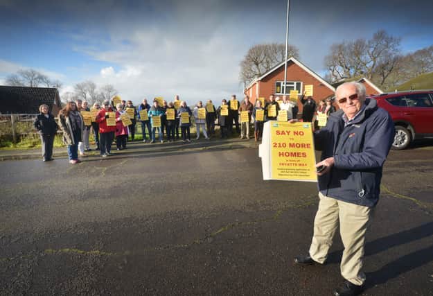 Residents opposed to a planning application to build 210 homes in fields off Fryatts Way in Bexhill.

Chris Ashford, Secretary of Ellerslie Area Residents' Association, is pictured with some of the residents in the background. SUS-220401-121512001