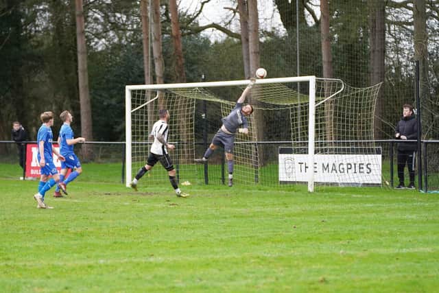Heath keeper Liam Matthews makes an excellent save to tip the ball over the bar