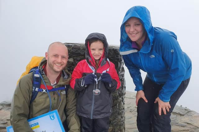 Paige, her dad Mark, and her mum Samantha, reached the top of the mountain despite the weather not being on their side SUS-211222-171502001