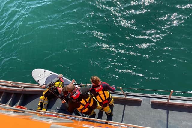 Newhaven RNLI rescuing a boy in Seaford Bay in Apr...to courtesy of RNLI and Rob 'Archie' Archibald