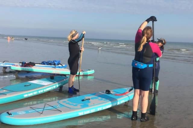 Tips on safety and technique are given during a SUP lesson