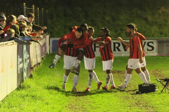 The Lewes players celebrate after Joe Taylor’s late penalty wraps up victory over Bognor on New Year's Day. Picture by Angela Brinkhurst