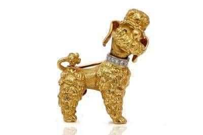 A 19ct gold brooch, designed as a standing poodle wearing a diamond set collar is set to be available at auction