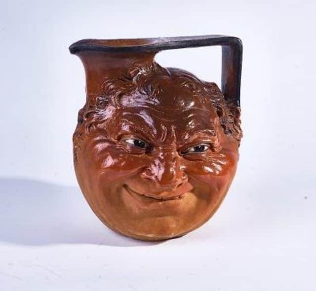A large Martin Brothers stoneware face jug is one of the items up for sale at the auction SUS-221101-135311001
